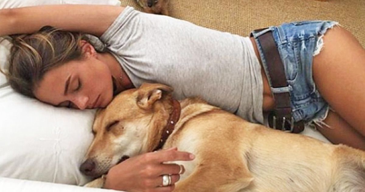 women sleeping with dogs