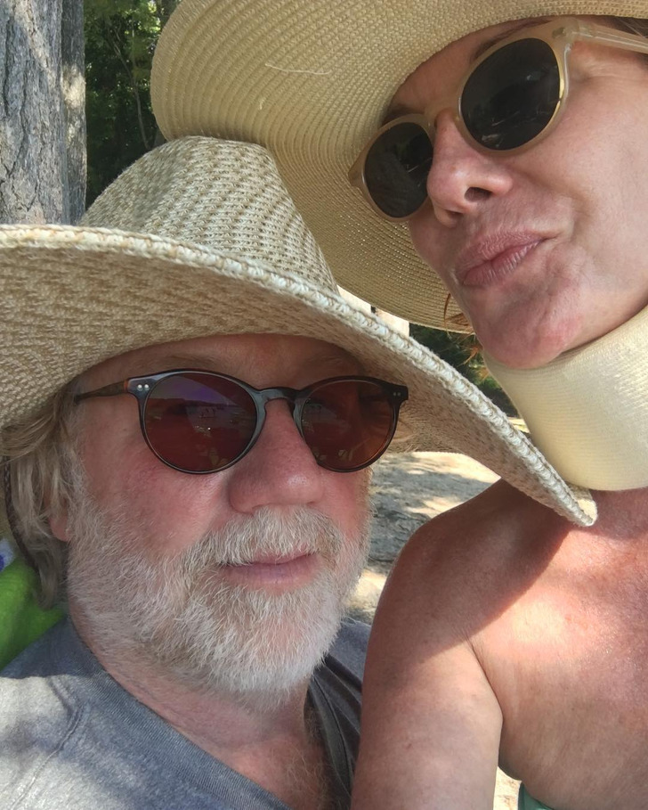 Melissa Gilbert and husband take a selfie wearing sunglasses and straw hats.