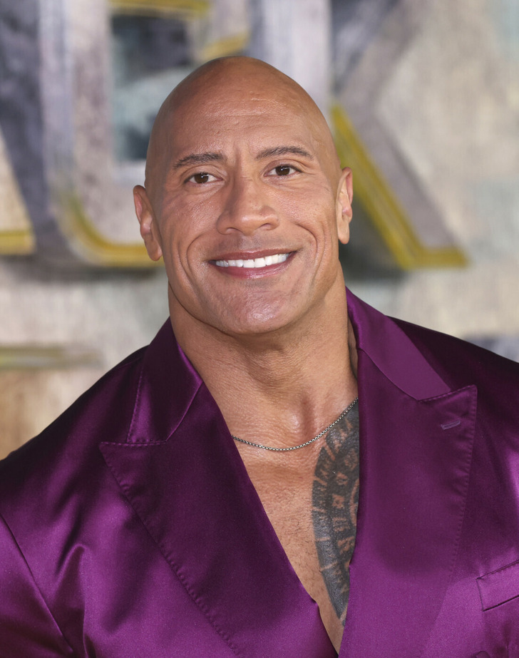 The Rock looking handsome in a purple satin suit.
