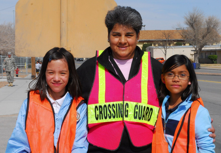 Illustrative photo: a school crossing guard with two students in Texas