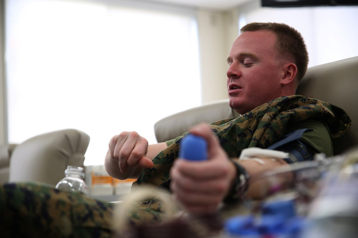 Illustrative photo: a service member donating platelets at a blood bank