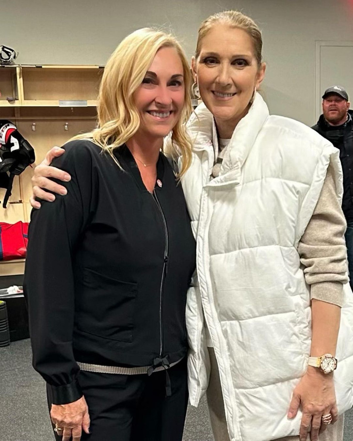 Celine Dion posing for a photo with a blonde lady.