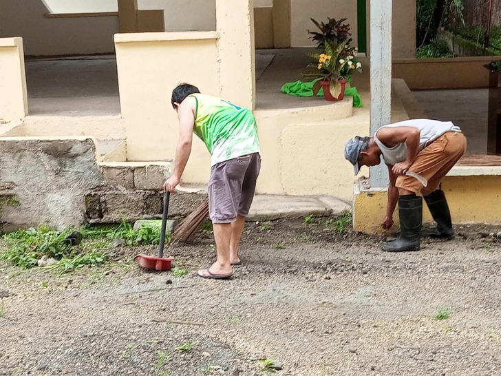 Volunteers clean a schoolyard during Brigada Eskwela, the Philippines, 2024