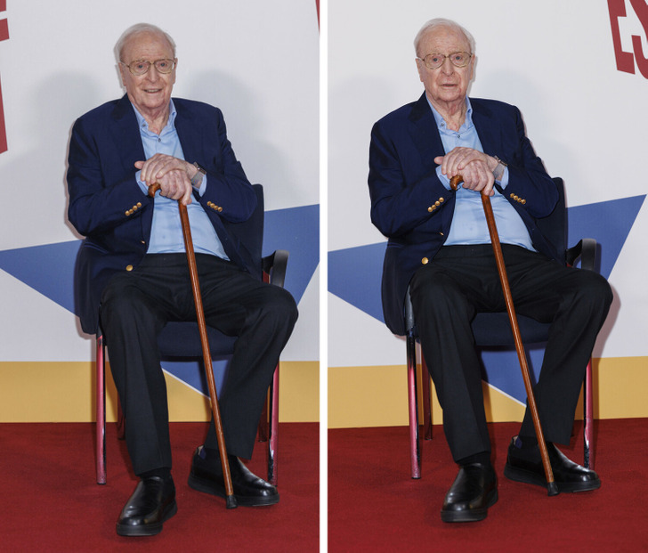 Sir Michael Caine sitting in a chair holding a cane.