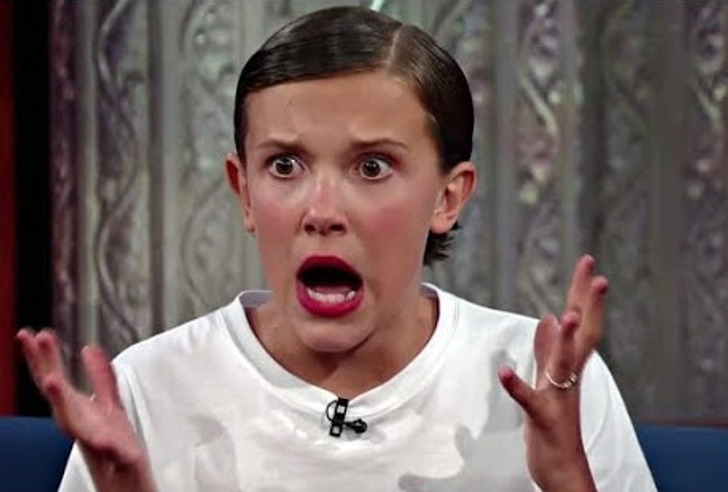 Young Millie Bobby Brown with a surprised face during an interview.