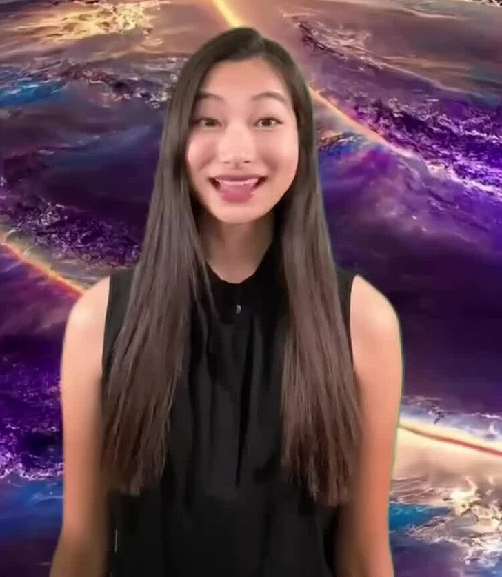A brunette asian woman speaking to the camera.