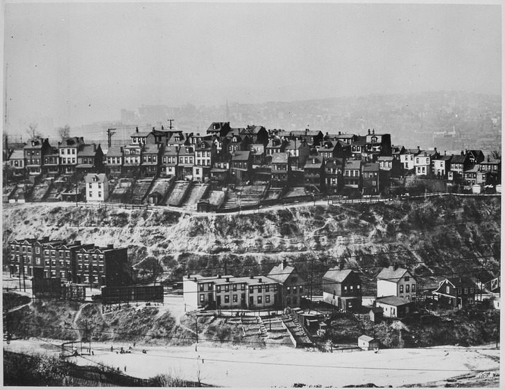 About 1940: houses on a Pittsburgh hillside, the city behind them in smoke