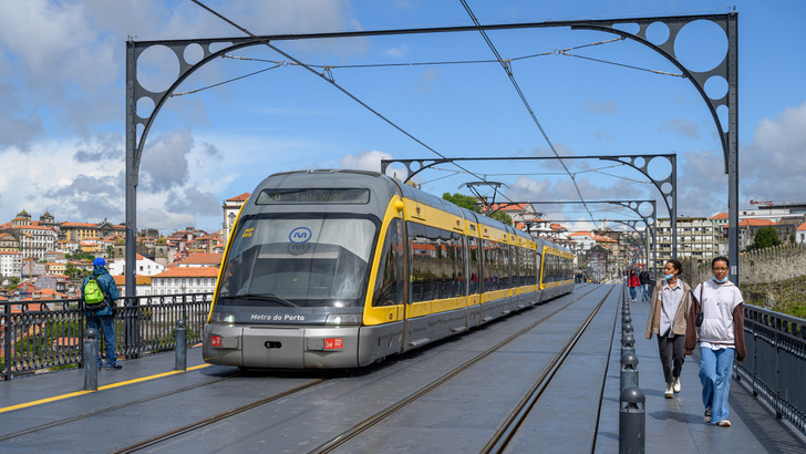 A Porto metro train crossing the Dom Luís I Bridge