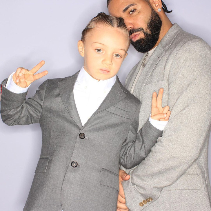 Drake and his son, both wearing grey suits.