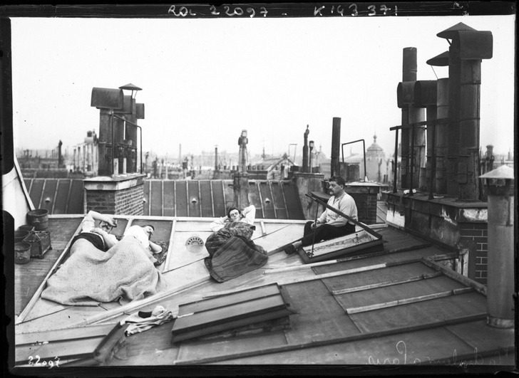 People asleep on a Paris rooftop during a heat wave, July 1912