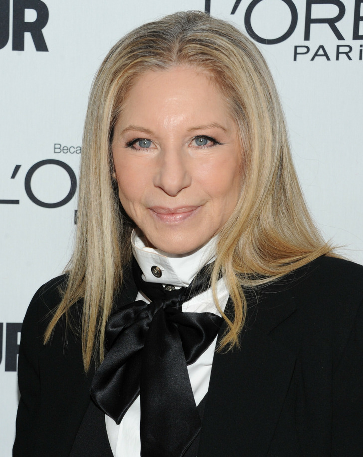 Barbra Streisand wearing a black suit and black bow on her neck.