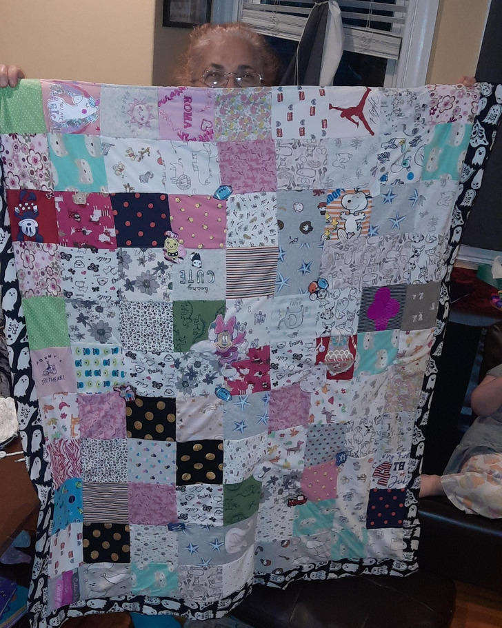 A Shy Grandma Posed With the Quilt She Made From Her Granddaughters’ Onesies