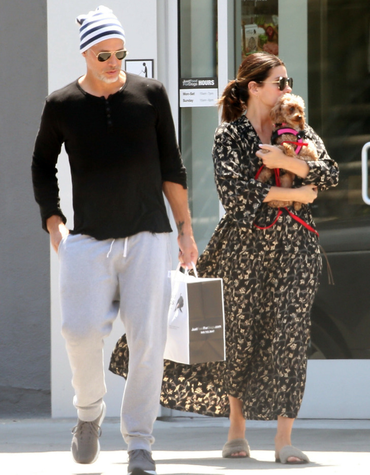 Sandra Bullock holding a puppy and shopping with Bryan Randall.