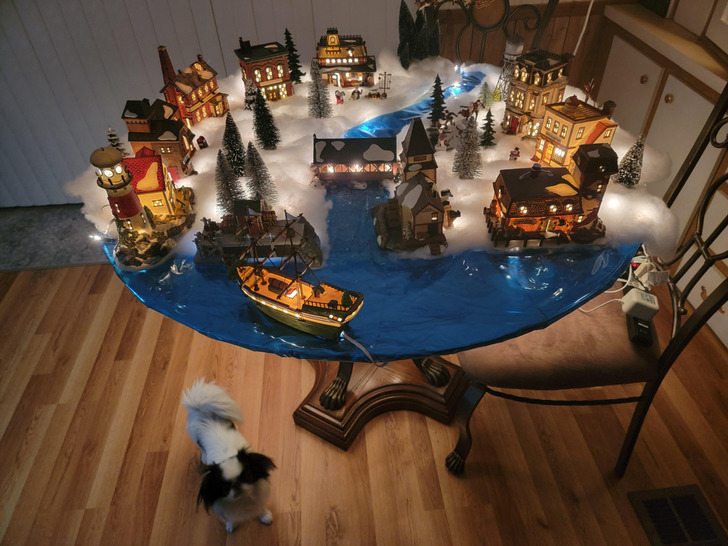 A Village on a Round Table That Stayed Up After Christmas, Guarded by a “Piranha”