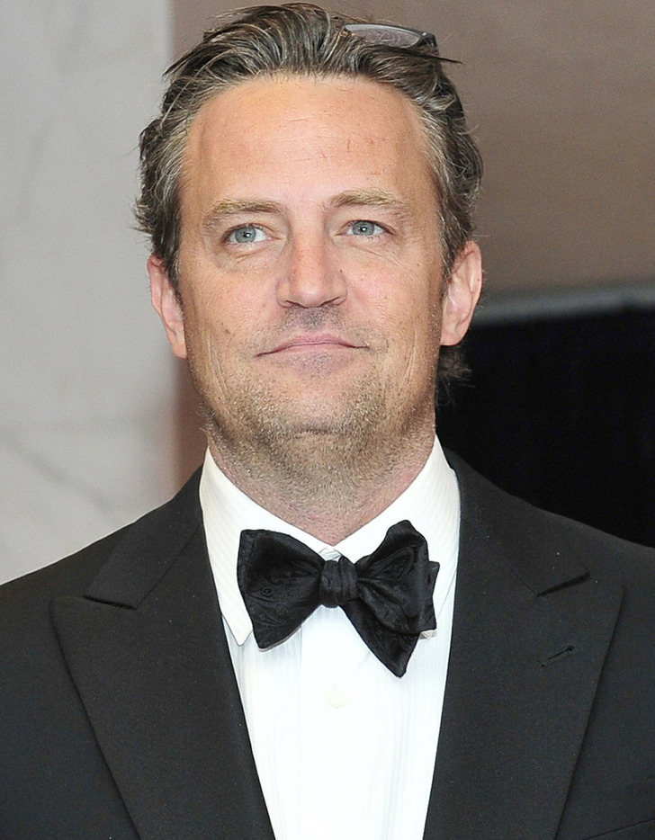 Matthew Perry looking good in a black suit and bow tie.