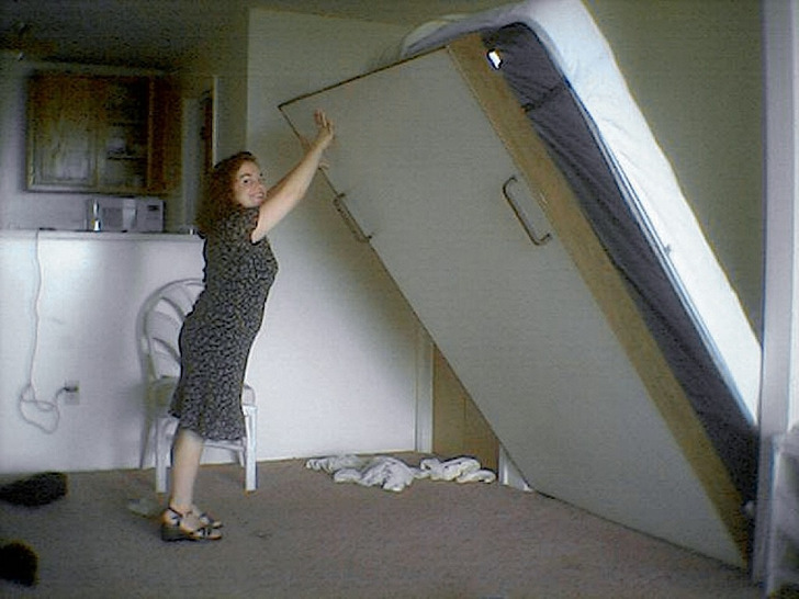 A Murphy bed folding down from the wall, 2006