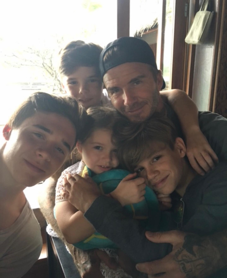 A group selfie of David Beckham and his three sons and a daughter.