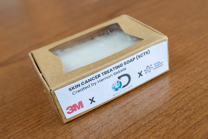 A small pack titled "Skin cancer treating soap" kept on a wooden table.