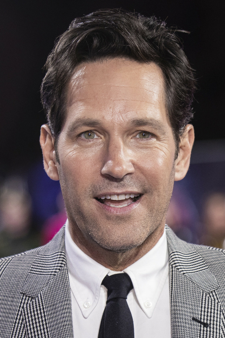 Close-up of a portrait of Paul Rudd in a striped suit and tie.
