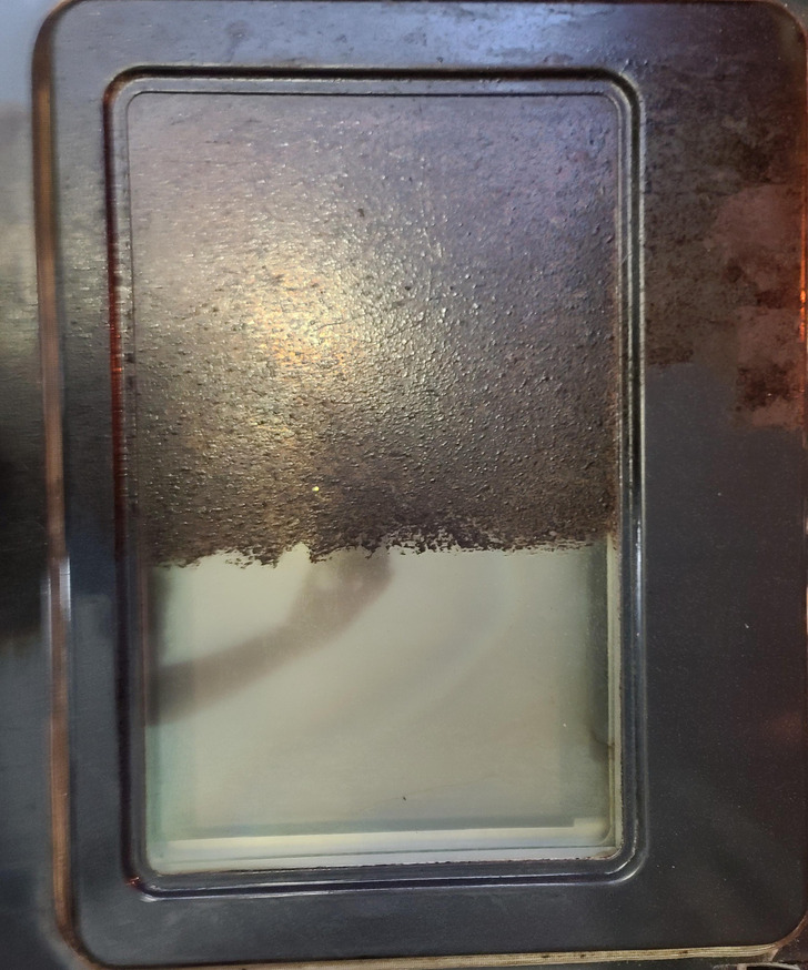 Well Over 10 Years of Grime on a Rental Oven Door, Taken Off With a Wet Pumice Stone