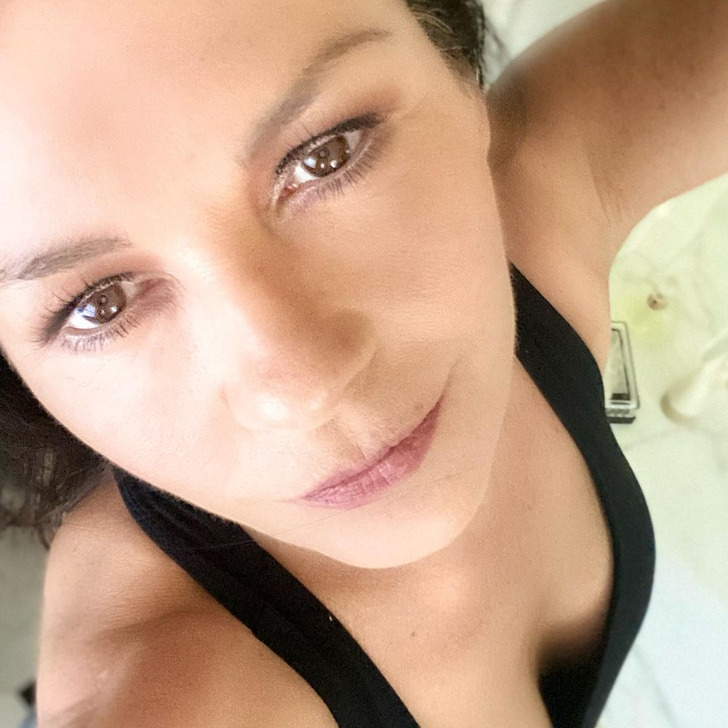 Close-up selfie of actress Catherine Zeta-Jones wearing a black tank top.
