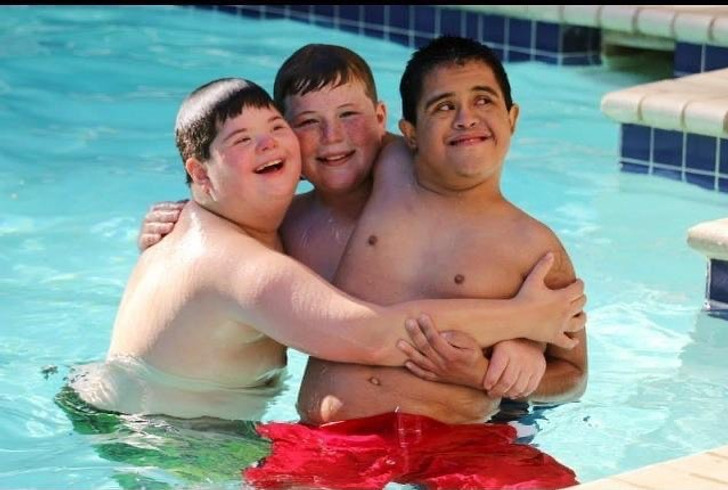 Three boys in the pool, two of them have Down syndrome.
