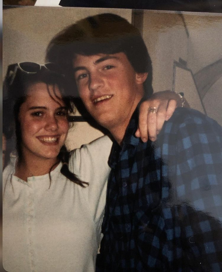 Young Matthew Perry and Ione Skye smiling for the camera.