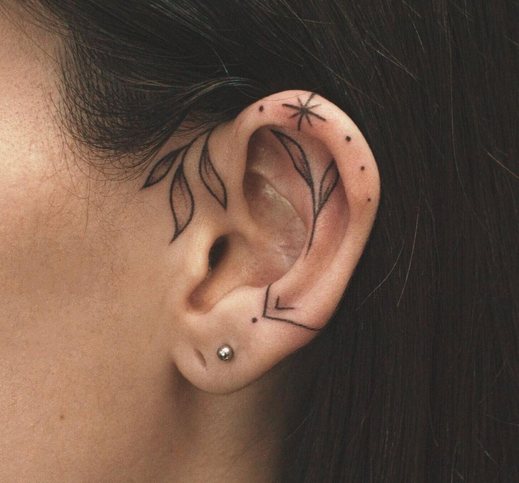 Minimalist moon and star tattoo on the ear