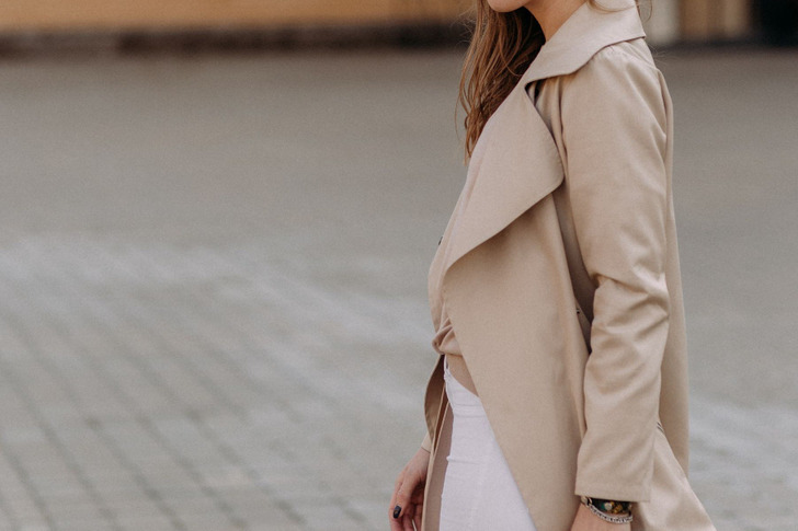 A beige trench coat over white