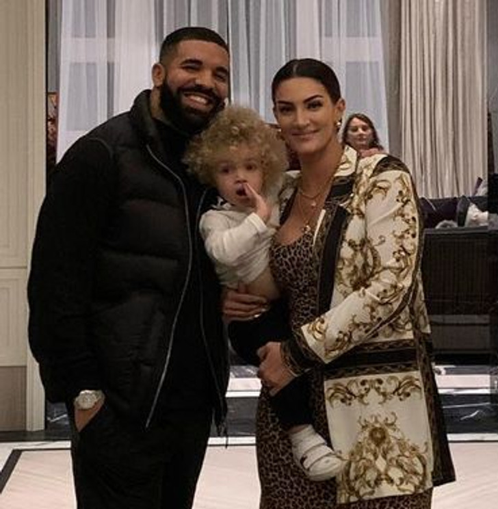 Drake wearing black clother with his son and the mother of his son.