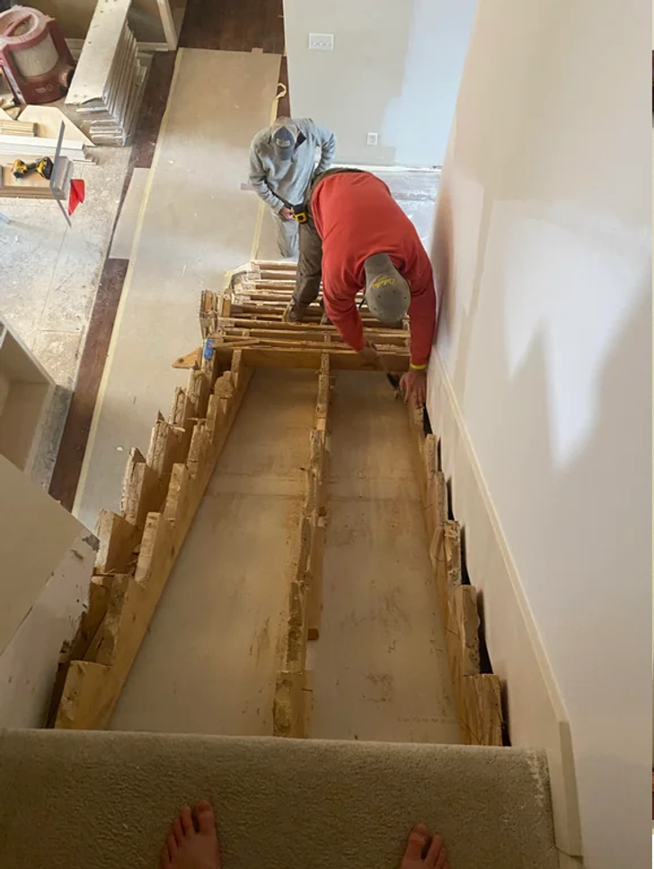 A man renovating the house stairs.