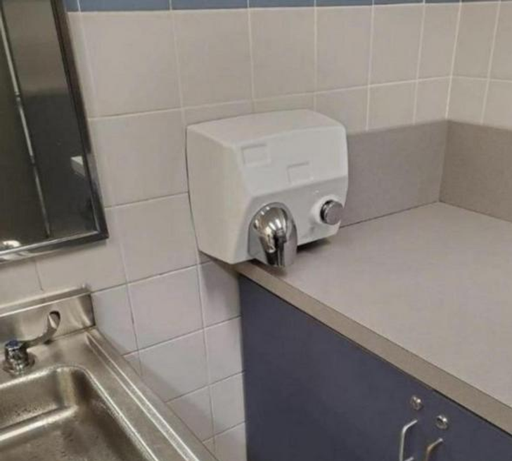 An automatic drying hand in a bathroom.
